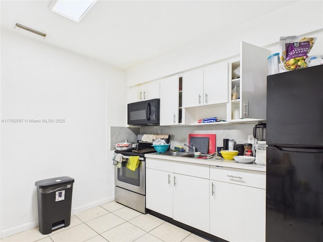 kitchen with open shelves, black appliances, light countertops, baseboards, and visible vents