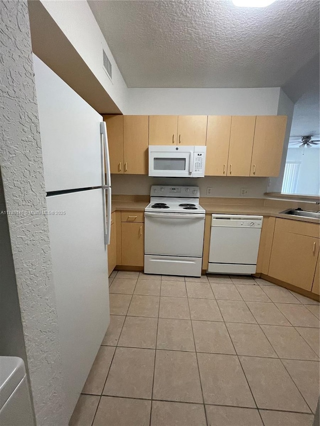 802 Belmont Ln Unit 802, North Lauderdale, FL 33068 - kitchen with visible vents, light tile patterned floors, white appliances, light brown cabinetry, and a textured ceiling