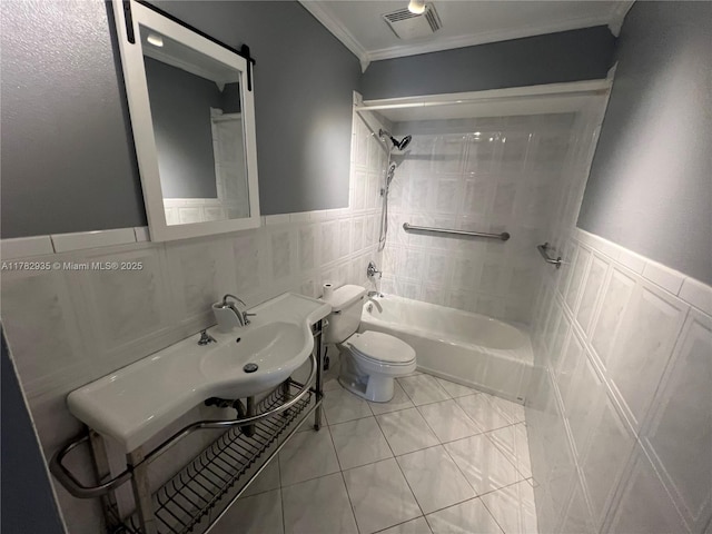 bathroom with ornamental molding, visible vents, a wainscoted wall, toilet, and washtub / shower combination