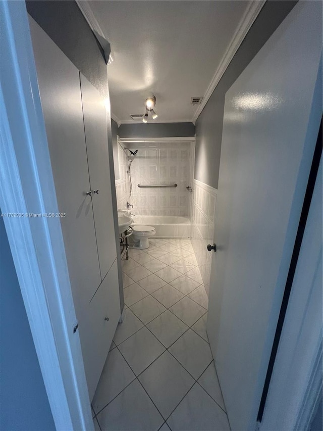 full bathroom featuring ornamental molding, tile patterned flooring, toilet, visible vents, and shower / bathing tub combination