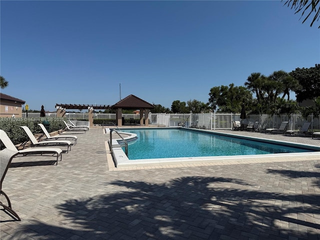 pool with a patio, a gazebo, and fence