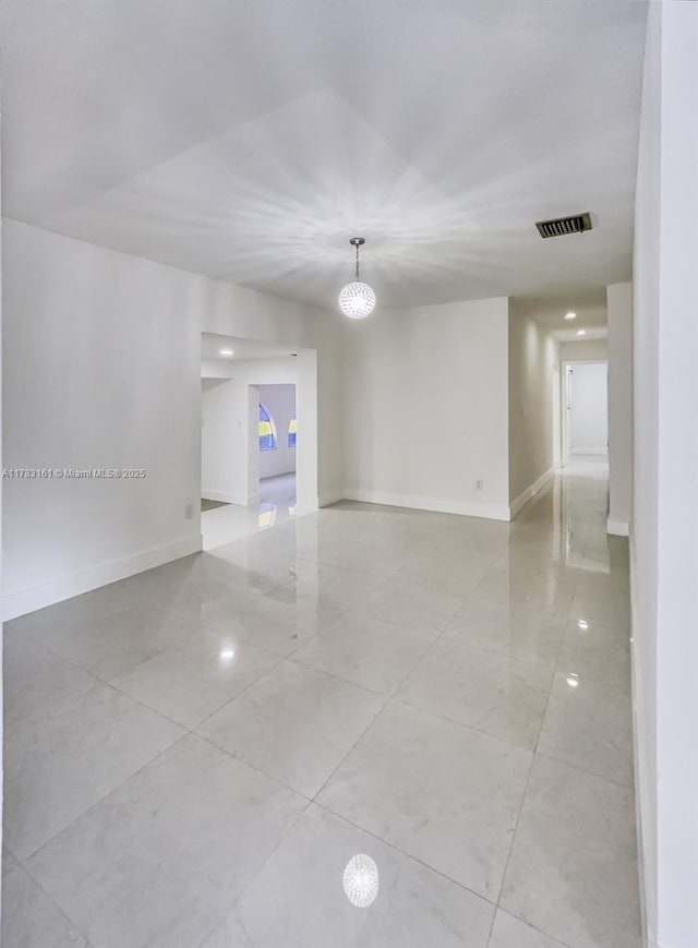 unfurnished room with baseboards and light tile patterned floors