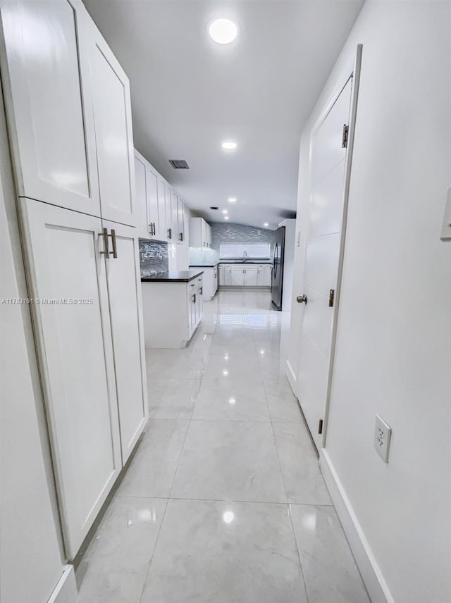 hallway with baseboards and recessed lighting
