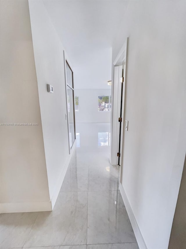 hall featuring baseboards