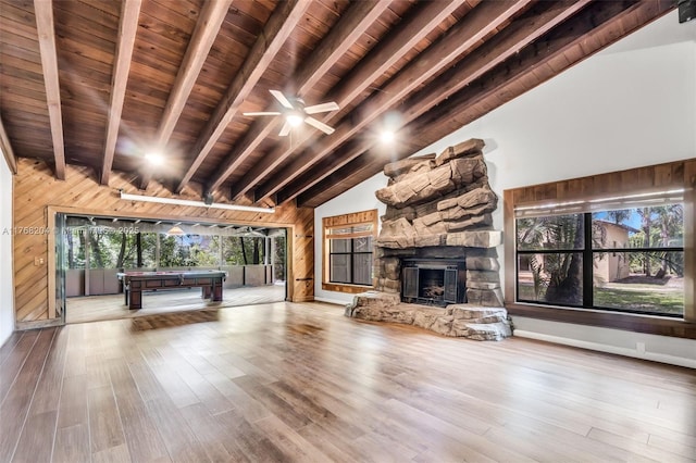 unfurnished living room with wood walls, wooden ceiling, and pool table