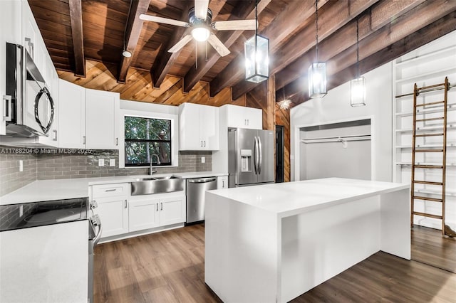 kitchen with dark wood-type flooring, wood ceiling, appliances with stainless steel finishes, a sink, and backsplash