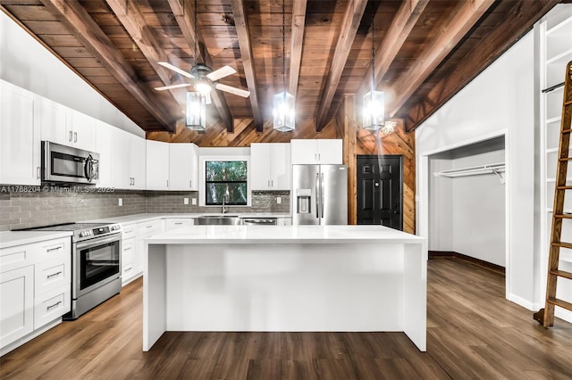 kitchen with tasteful backsplash, a sink, light countertops, appliances with stainless steel finishes, and wood ceiling
