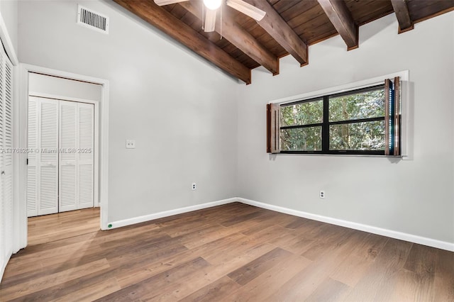 unfurnished room with beamed ceiling, ceiling fan, visible vents, wood ceiling, and wood finished floors
