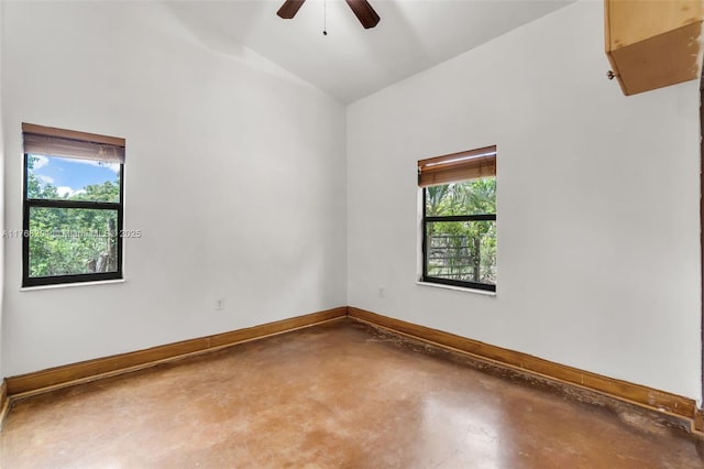 unfurnished room featuring finished concrete floors, ceiling fan, baseboards, and plenty of natural light