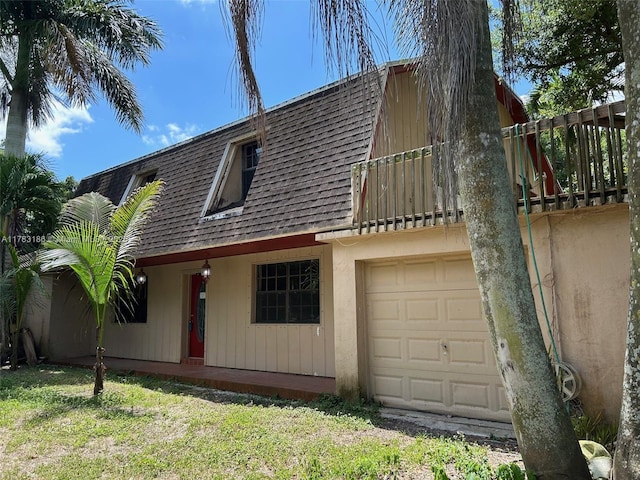 view of front facade featuring a garage and roof with shingles