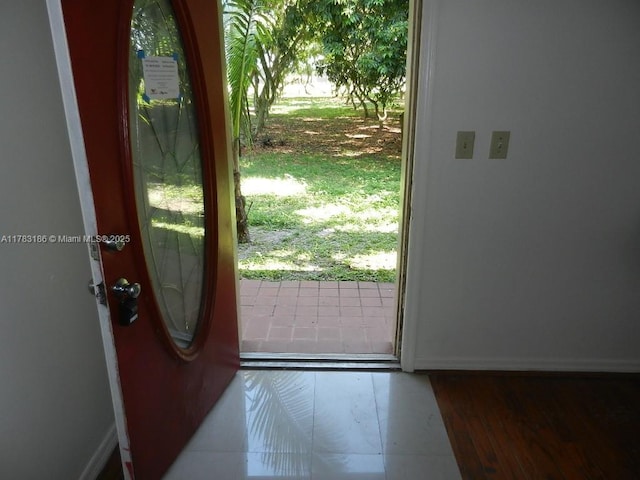 entryway featuring baseboards and plenty of natural light