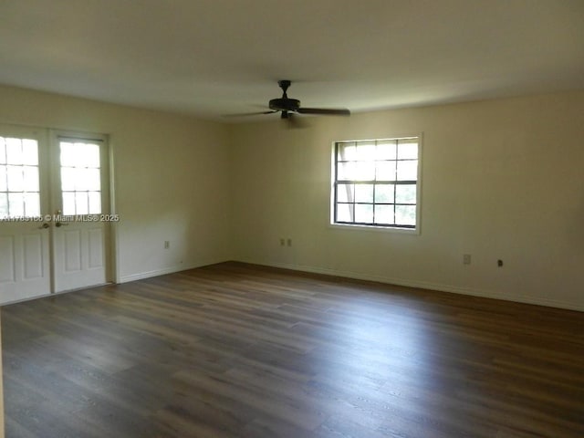 unfurnished room featuring plenty of natural light, dark wood-type flooring, ceiling fan, and french doors