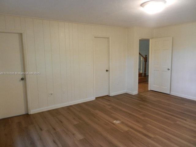 unfurnished bedroom with baseboards and wood finished floors