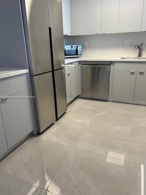 20301 W Country Club Dr Unit 830, Aventura, FL 33180 - kitchen featuring light countertops, a sink, white cabinetry, and appliances with stainless steel finishes