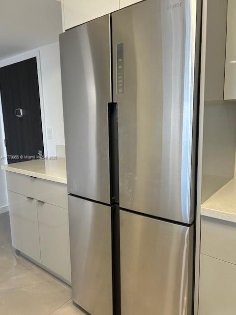20301 W Country Club Dr Unit 830, Aventura, FL 33180 - kitchen featuring light countertops, light tile patterned floors, modern cabinets, and freestanding refrigerator