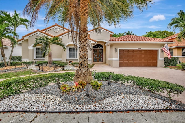 4060 SW 152nd Ave, Miramar, FL 33027 - mediterranean / spanish house featuring a garage, stucco siding, concrete driveway, and a tile roof