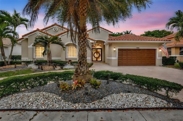 4060 SW 152nd Ave, Miramar, FL 33027 - mediterranean / spanish house with a tile roof, an attached garage, concrete driveway, and stucco siding