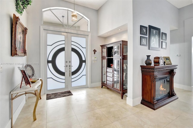 4060 SW 152nd Ave, Miramar, FL 33027 - foyer entrance with french doors, baseboards, a high ceiling, and light tile patterned flooring