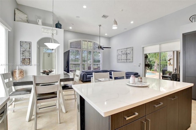 4060 SW 152nd Ave, Miramar, FL 33027 - kitchen with recessed lighting, a high ceiling, a ceiling fan, a kitchen island, and visible vents