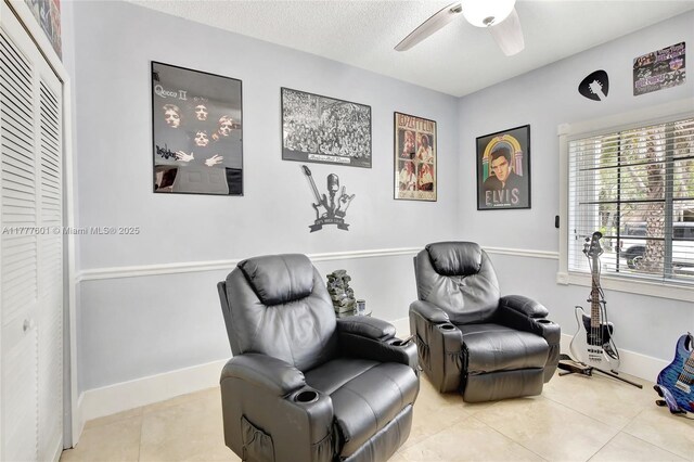 4060 SW 152nd Ave, Miramar, FL 33027 - living area featuring light tile patterned floors, baseboards, a ceiling fan, and a textured ceiling