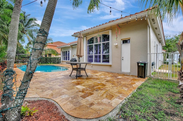 4060 SW 152nd Ave, Miramar, FL 33027 - back of house featuring stucco siding, an outdoor pool, a patio area, a tile roof, and fence