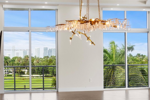 2001 Meridian Ave Unit 514, Miami Beach, FL 33139 - unfurnished dining area with a chandelier, recessed lighting, a healthy amount of sunlight, and a wall of windows