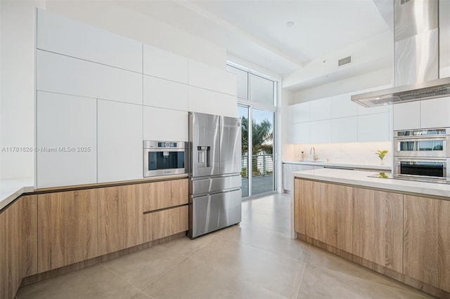 2001 Meridian Ave Unit 514, Miami Beach, FL 33139 - kitchen featuring modern cabinets, extractor fan, and stainless steel appliances