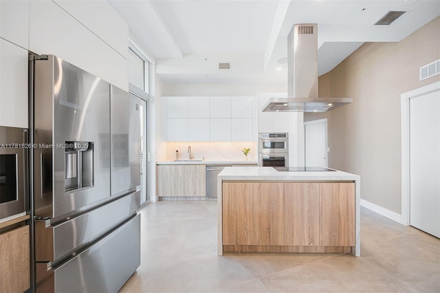 2001 Meridian Ave Unit 514, Miami Beach, FL 33139 - kitchen with modern cabinets, visible vents, a center island, appliances with stainless steel finishes, and island exhaust hood