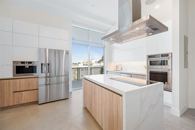 2001 Meridian Ave Unit 514, Miami Beach, FL 33139 - kitchen with a center island, appliances with stainless steel finishes, wall chimney exhaust hood, and modern cabinets