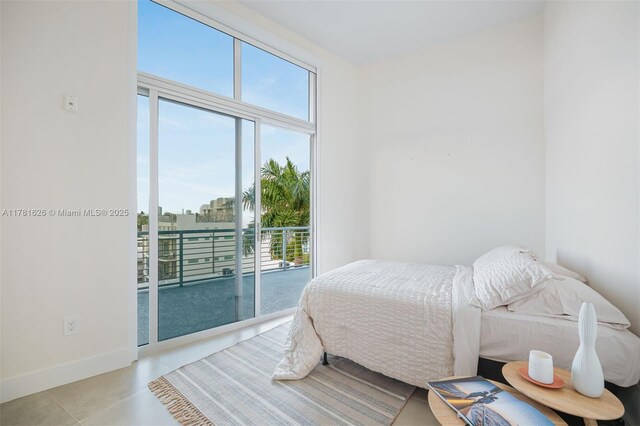 2001 Meridian Ave Unit 514, Miami Beach, FL 33139 - bedroom featuring multiple windows, baseboards, and access to outside