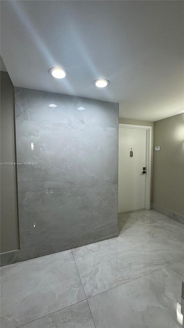 empty room with marble finish floor and recessed lighting