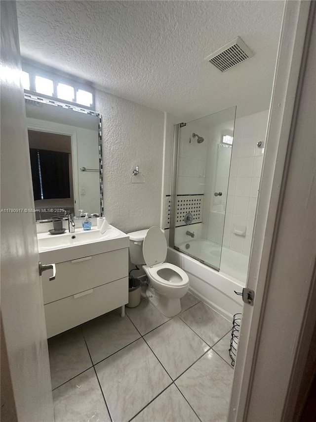 bathroom with visible vents, vanity, a textured wall, and a textured ceiling