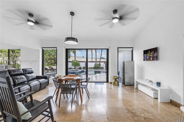 living room with a water view, baseboards, and a ceiling fan