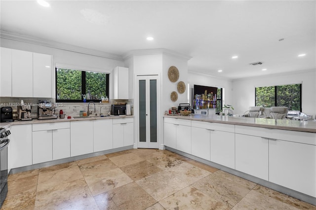 kitchen with decorative backsplash, a sink, visible vents, and recessed lighting