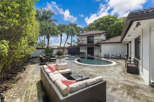 view of pool with a patio, an outdoor hangout area, a fenced backyard, and a pool with connected hot tub