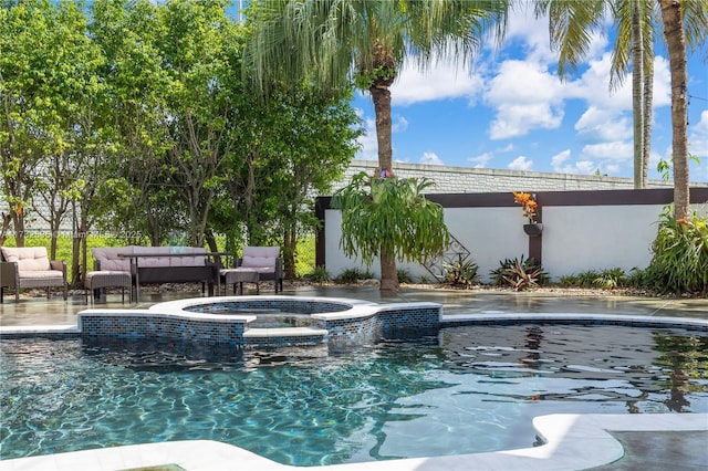 view of pool with an outdoor living space and a pool with connected hot tub
