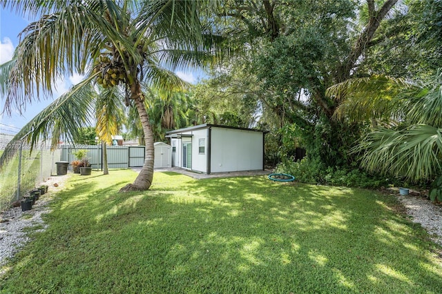 view of yard with a fenced backyard and an outbuilding