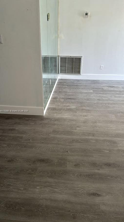 6855 NW 9th St, Margate, FL 33063 - empty room with visible vents, baseboards, and wood finished floors