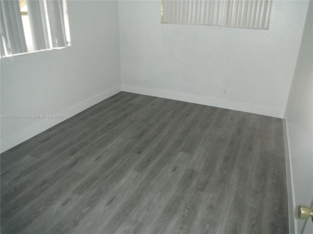 6855 NW 9th St, Margate, FL 33063 - empty room featuring dark wood-style flooring and baseboards