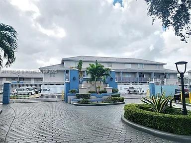 8390 NW 103rd St Unit 205H, Hialeah Gardens, FL 33016 - view of building exterior with decorative driveway
