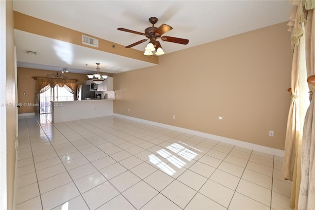 8390 NW 103rd St Unit 205H, Hialeah Gardens, FL 33016 - spare room featuring ceiling fan with notable chandelier, light tile patterned floors, and visible vents