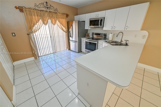 8390 NW 103rd St Unit 205H, Hialeah Gardens, FL 33016 - kitchen with light tile patterned floors, appliances with stainless steel finishes, light countertops, a sink, and baseboards