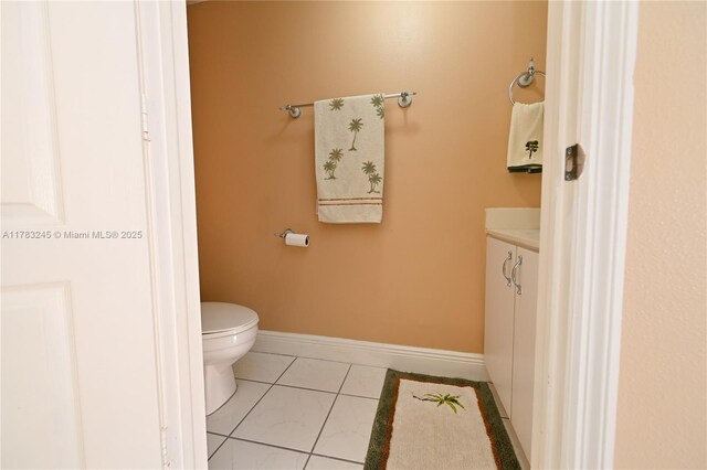 8390 NW 103rd St Unit 205H, Hialeah Gardens, FL 33016 - half bath featuring tile patterned floors, vanity, baseboards, and toilet