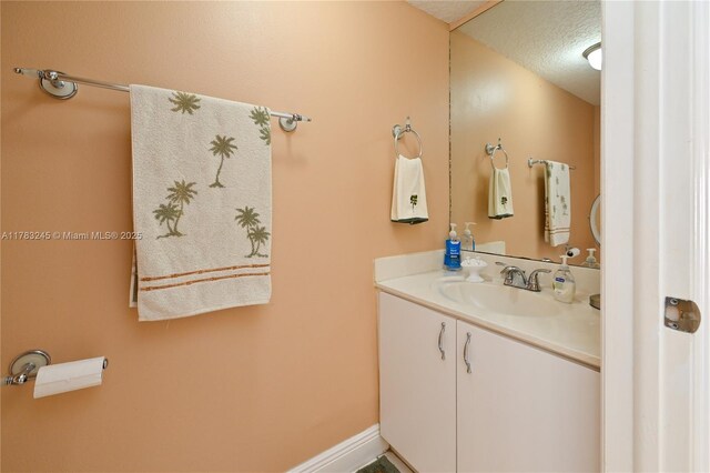 8390 NW 103rd St Unit 205H, Hialeah Gardens, FL 33016 - bathroom featuring a textured ceiling and vanity