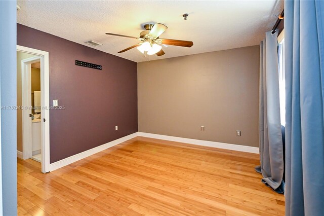8390 NW 103rd St Unit 205H, Hialeah Gardens, FL 33016 - spare room featuring light wood-style floors, baseboards, a ceiling fan, and visible vents