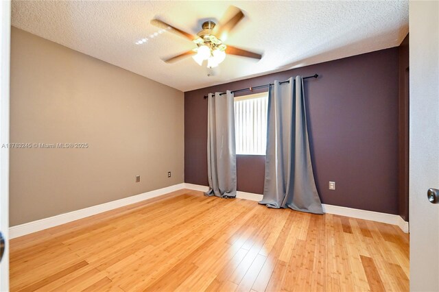 8390 NW 103rd St Unit 205H, Hialeah Gardens, FL 33016 - empty room featuring ceiling fan, light wood finished floors, baseboards, and a textured ceiling