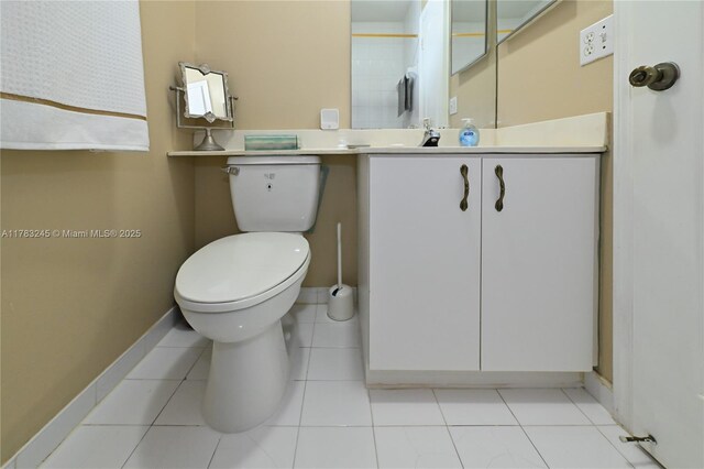 8390 NW 103rd St Unit 205H, Hialeah Gardens, FL 33016 - half bathroom featuring toilet, vanity, and baseboards