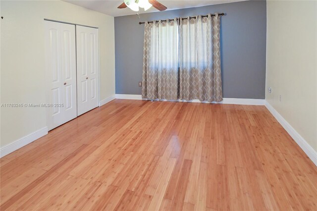 8390 NW 103rd St Unit 205H, Hialeah Gardens, FL 33016 - unfurnished bedroom featuring a closet, baseboards, a ceiling fan, and wood finished floors