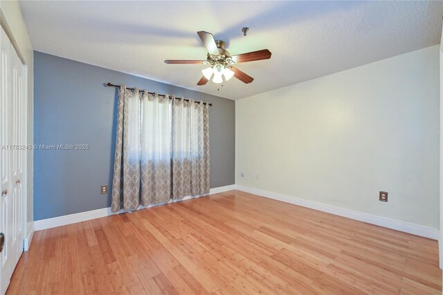 8390 NW 103rd St Unit 205H, Hialeah Gardens, FL 33016 - spare room featuring baseboards, a ceiling fan, and light wood-style floors