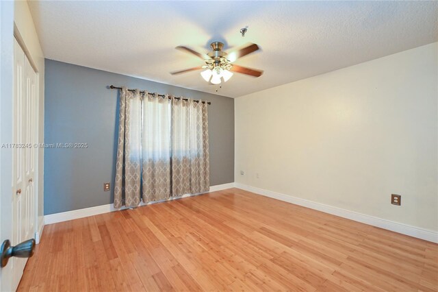 8390 NW 103rd St Unit 205H, Hialeah Gardens, FL 33016 - empty room with light wood-type flooring, baseboards, and a ceiling fan
